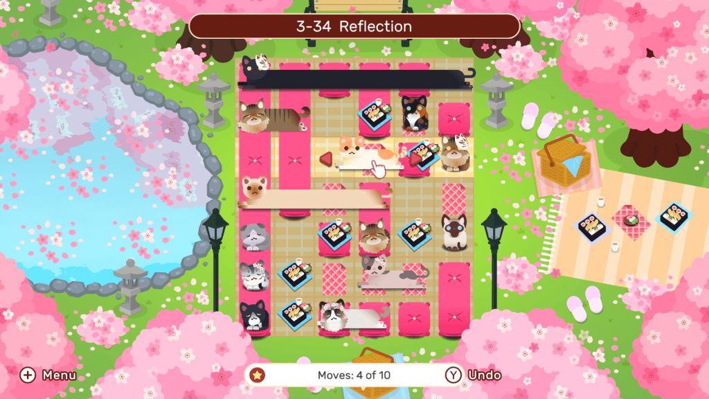 Screenshot of third world in Nekograms with cats sitting on a picnic blanket in a sakura park.