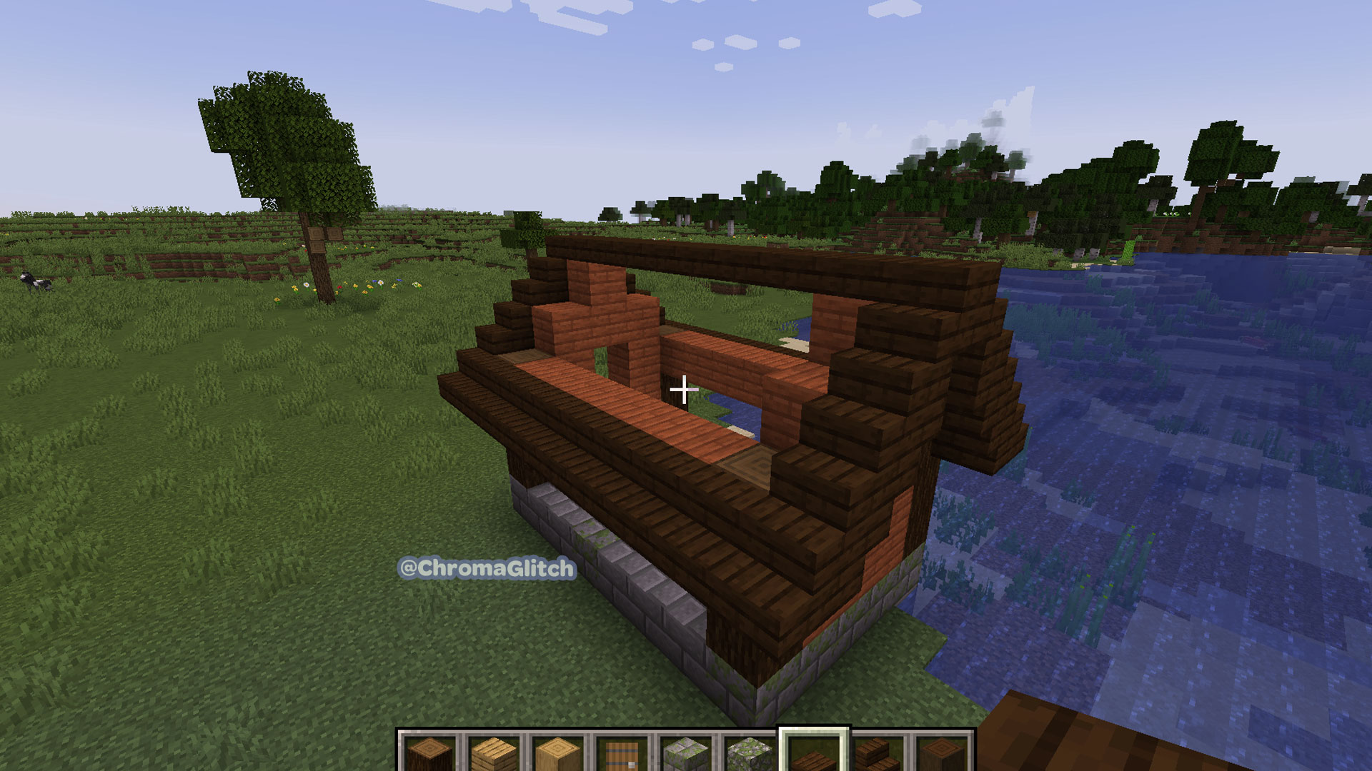 Screenshot of a house being built in Minecraft the roof is being constructed out of wood stairs and slabs.