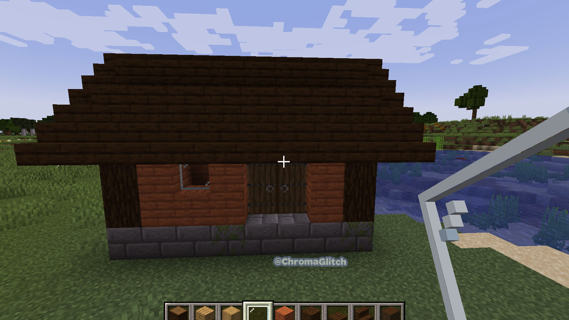 Front profile view of the house in Minecraft, with the front and back wall added with doors and windows.